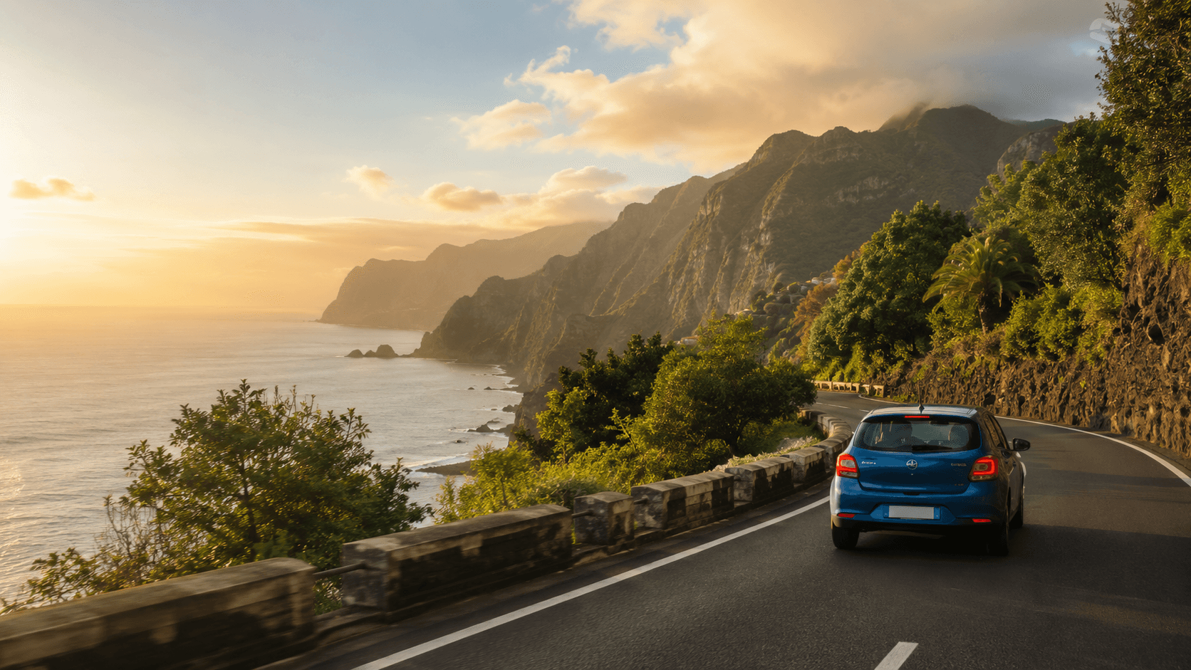 Car driving along a scenic coastal road in Madeira at golden hour